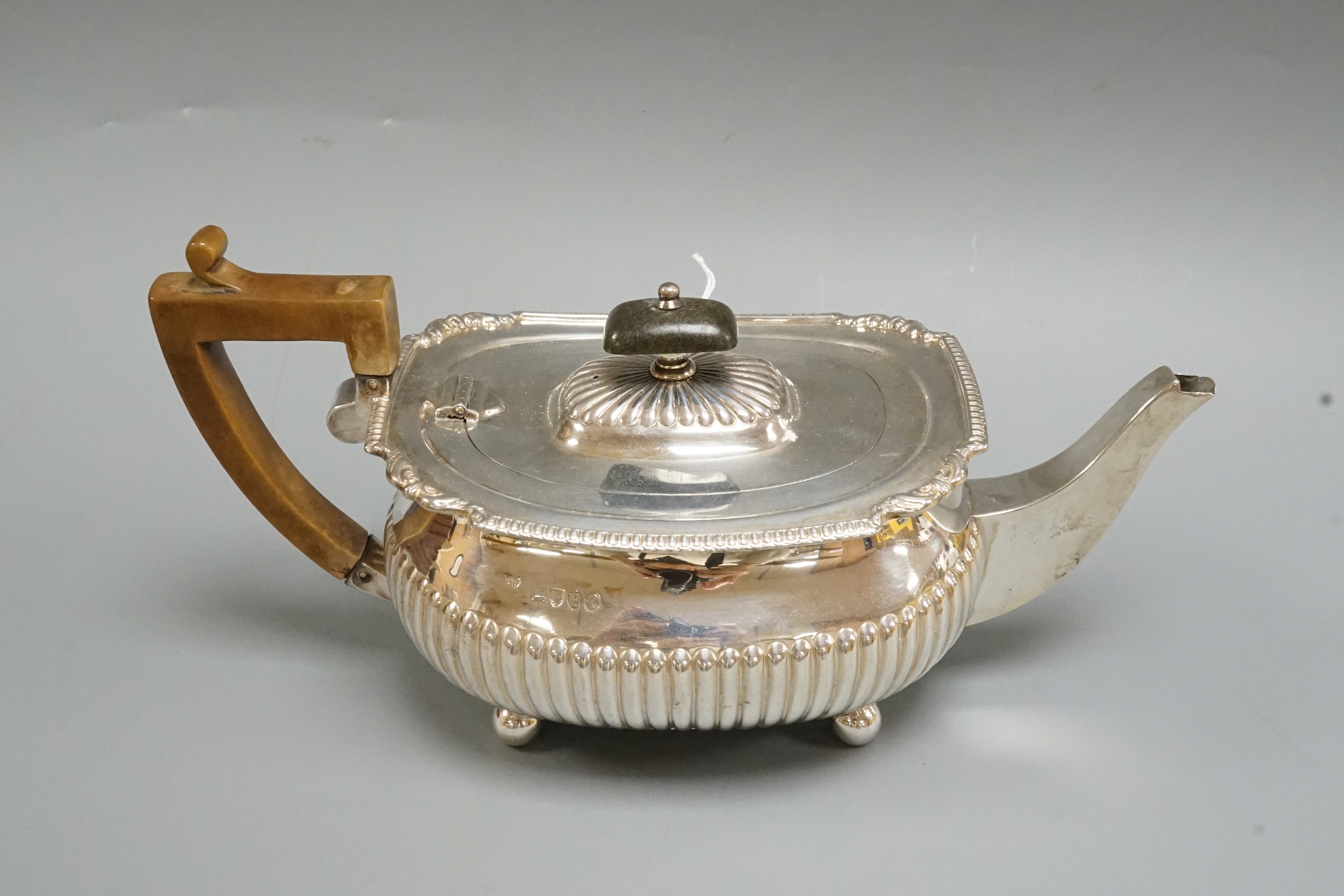 A Victorian demi-fluted silver teapot, Edward Hutton, London, 1883, gross weight 16oz.